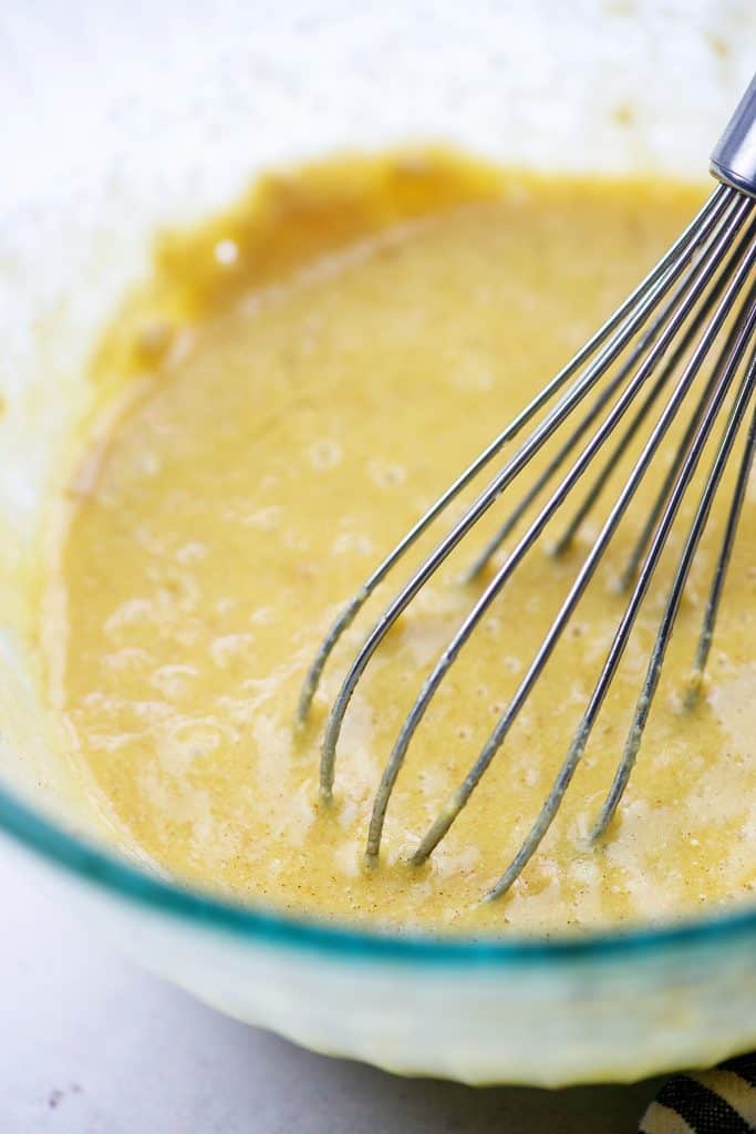 coconut flour pancake batter in glass bowl with wire whisk