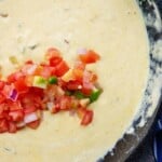 keto queso recipe in cast iron skillet with pico on top