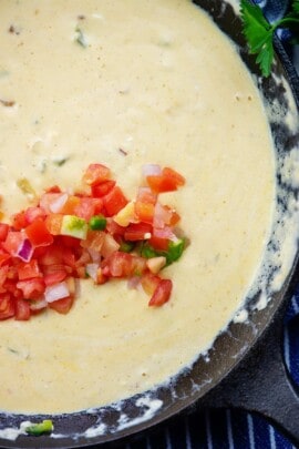 keto queso recipe in cast iron skillet with pico on top