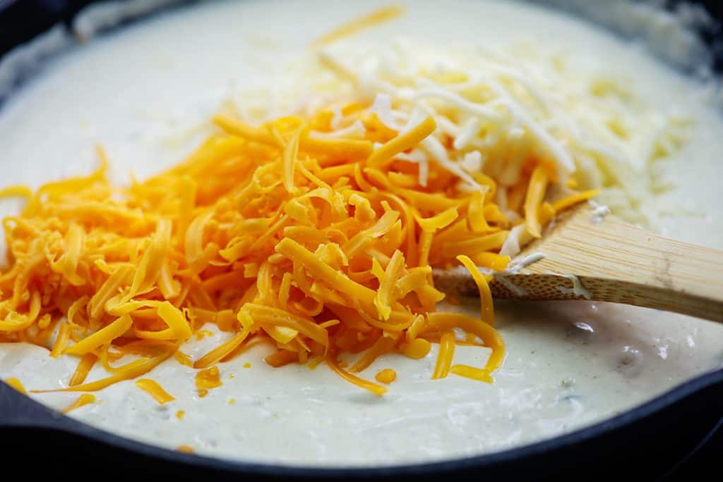 shredded cheese on top of cream sauce