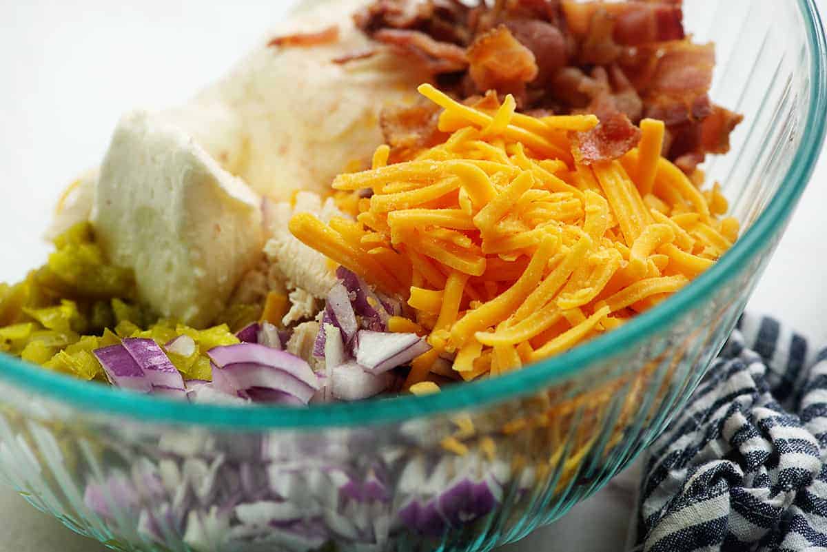 ingredients for spicy chicken salad recipe in glass bowl