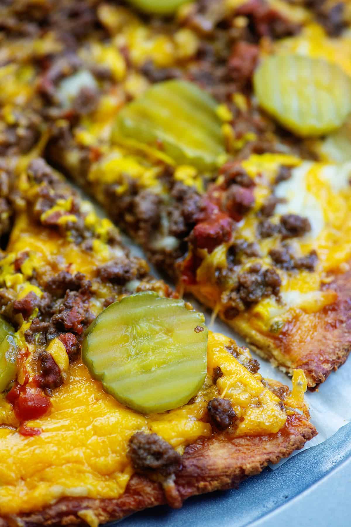 fathead pizza with ground beef, cheese, and pickles on pizza pan