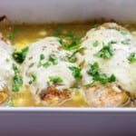 cheese topped chicken baked in salsa verde in white baking dish