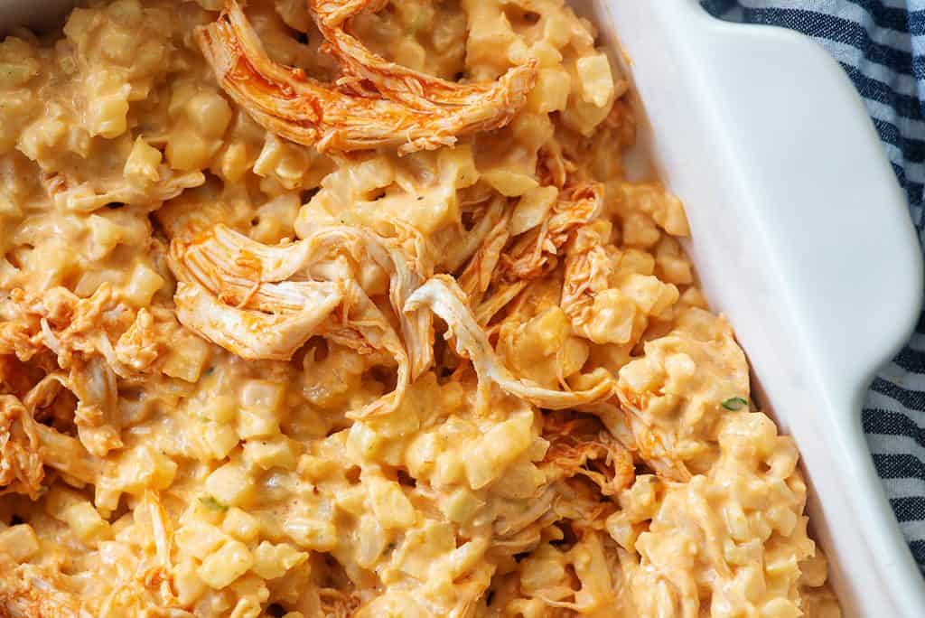 low carb buffalo chicken casserole in white baking dish