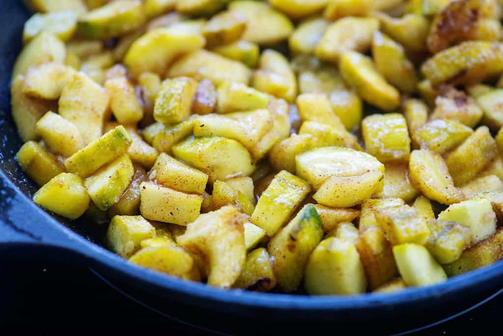 zucchini cooked in spices in cast iron skillet