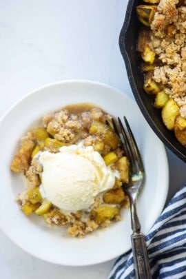 zucchini cobbler with ice cream on top on white plate