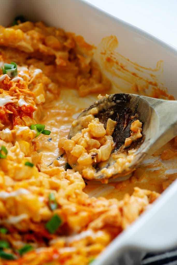 buffalo chicken casserole made with cauliflower rice in white baking dish