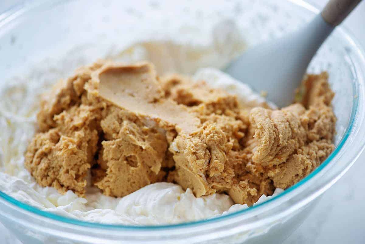 bowl of whipped cream with peanut butter pie filling on top