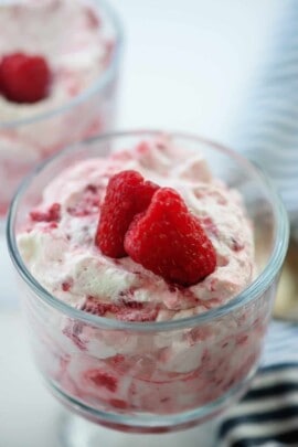 raspberries and cream in glass dish