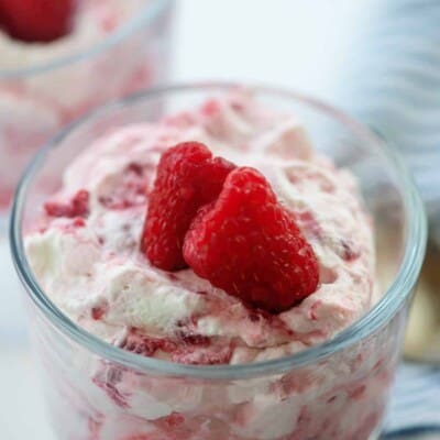 raspberries and cream in glass dish