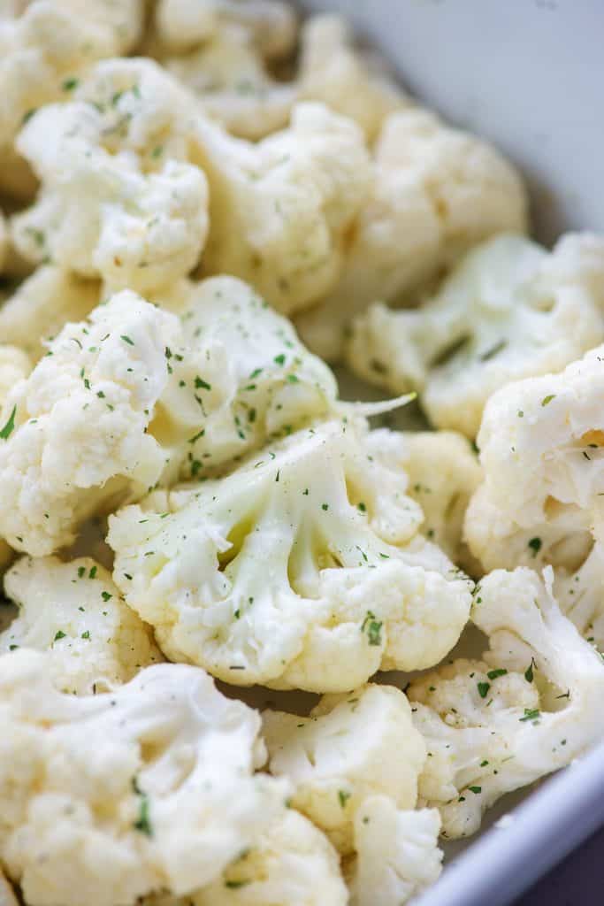 seasoned cauliflower in white baking dish