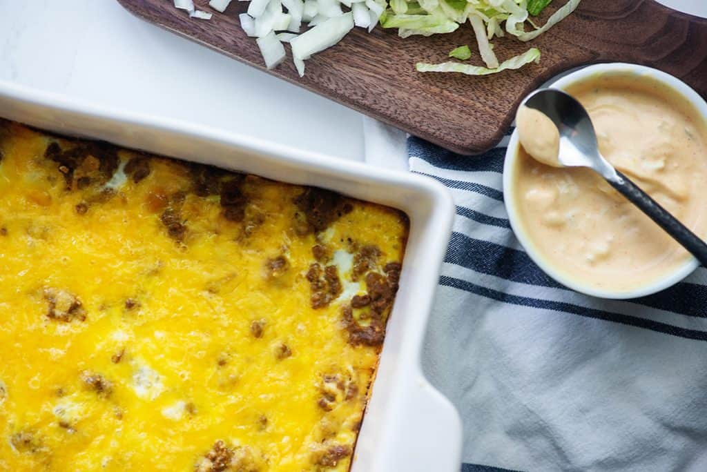 casserole in white dish with bowl of homemade big mac sauce 