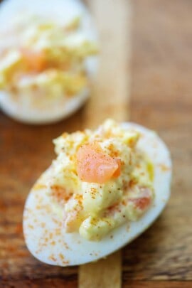 deviled egg topped with smoked salmon and Old Bay seasoning