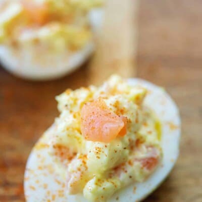 deviled egg topped with smoked salmon and Old Bay seasoning
