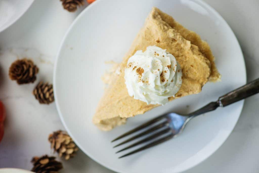 pumpkin cream pie on white plate