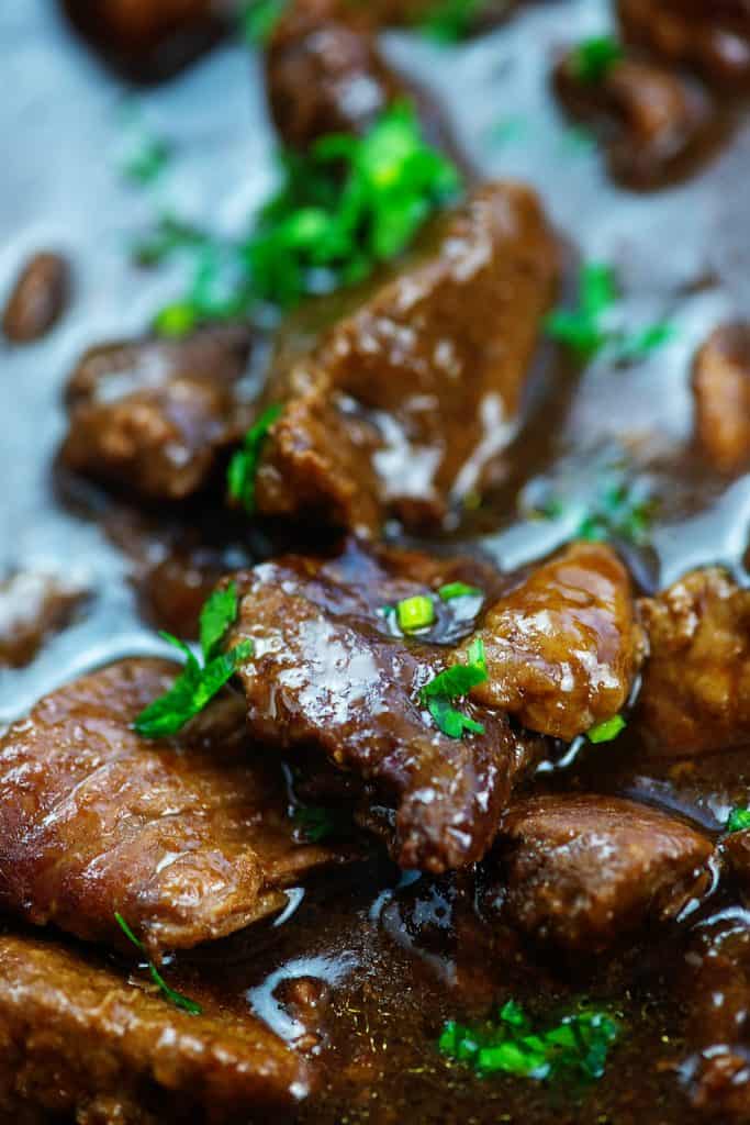 chunks of beef in thick gravy with parsley on top