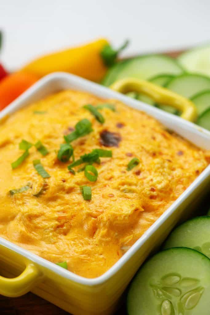 cheesy buffalo chicken dip in yellow baking dish