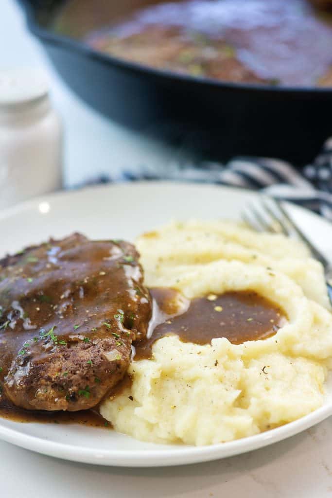 salisbury steak and mashed cauliflower on white plate