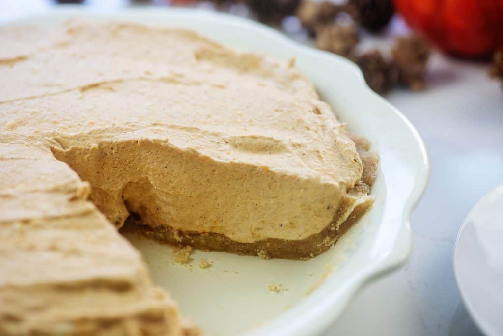 pumpkin pie with slice taken out