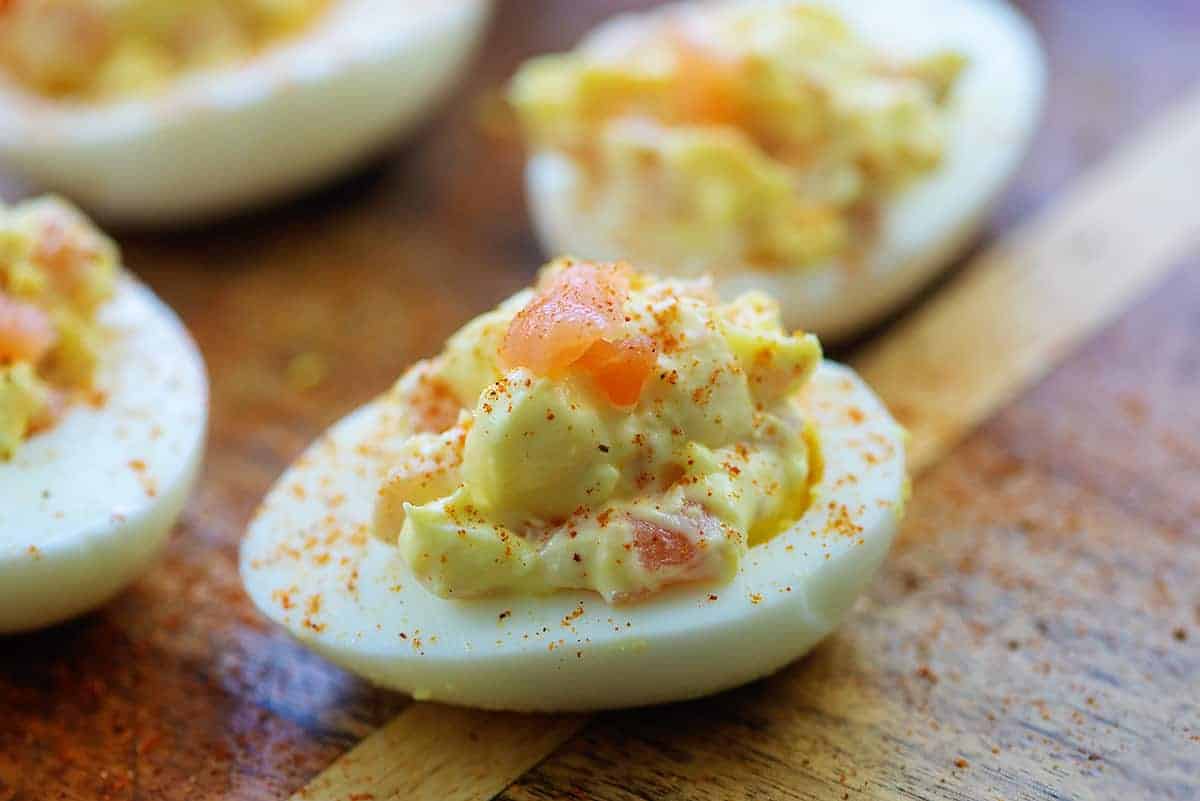 deviled eggs on wooden cutting board