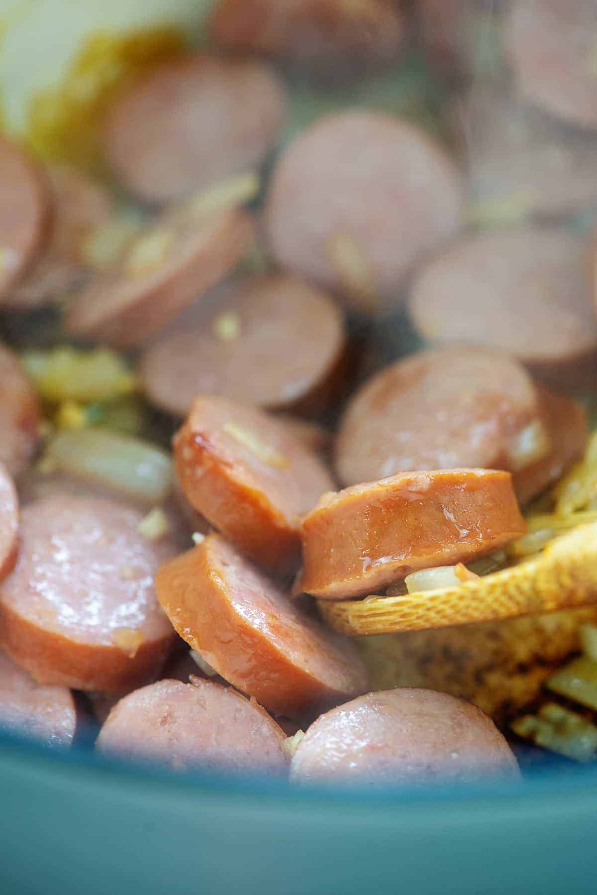sauteed sausage and onions in stock pot