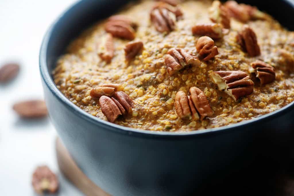 low carb oatmeal recipe topped with pecans in black bowl