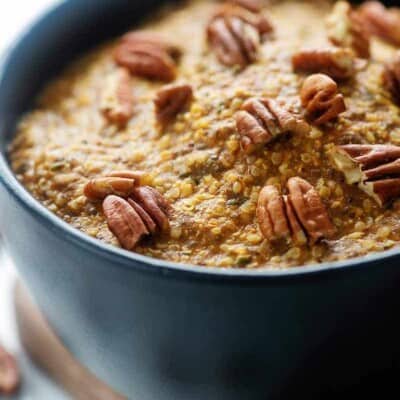 low carb oatmeal recipe topped with pecans in black bowl