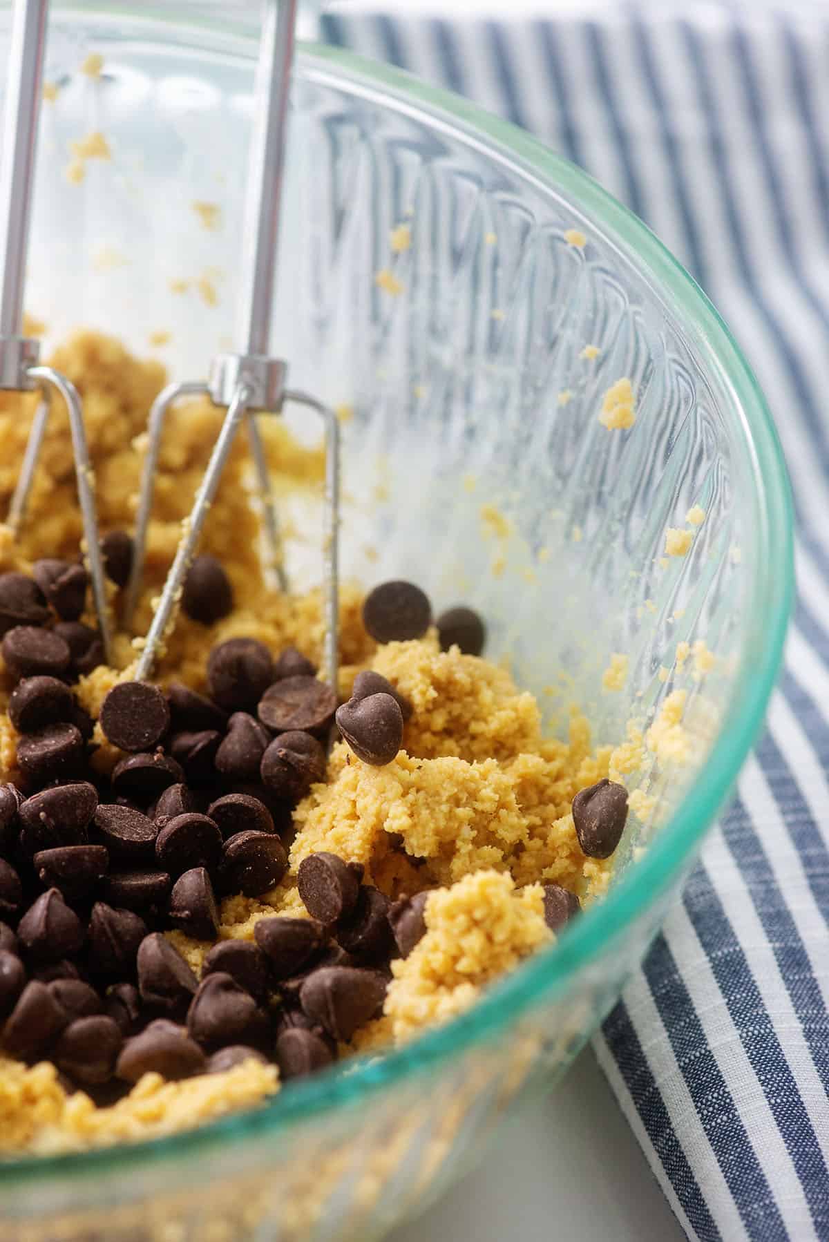 chocolate chip cookie dough in glass mixing bowl.