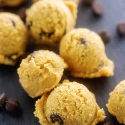 chocolate chip cookie balls on black surface.