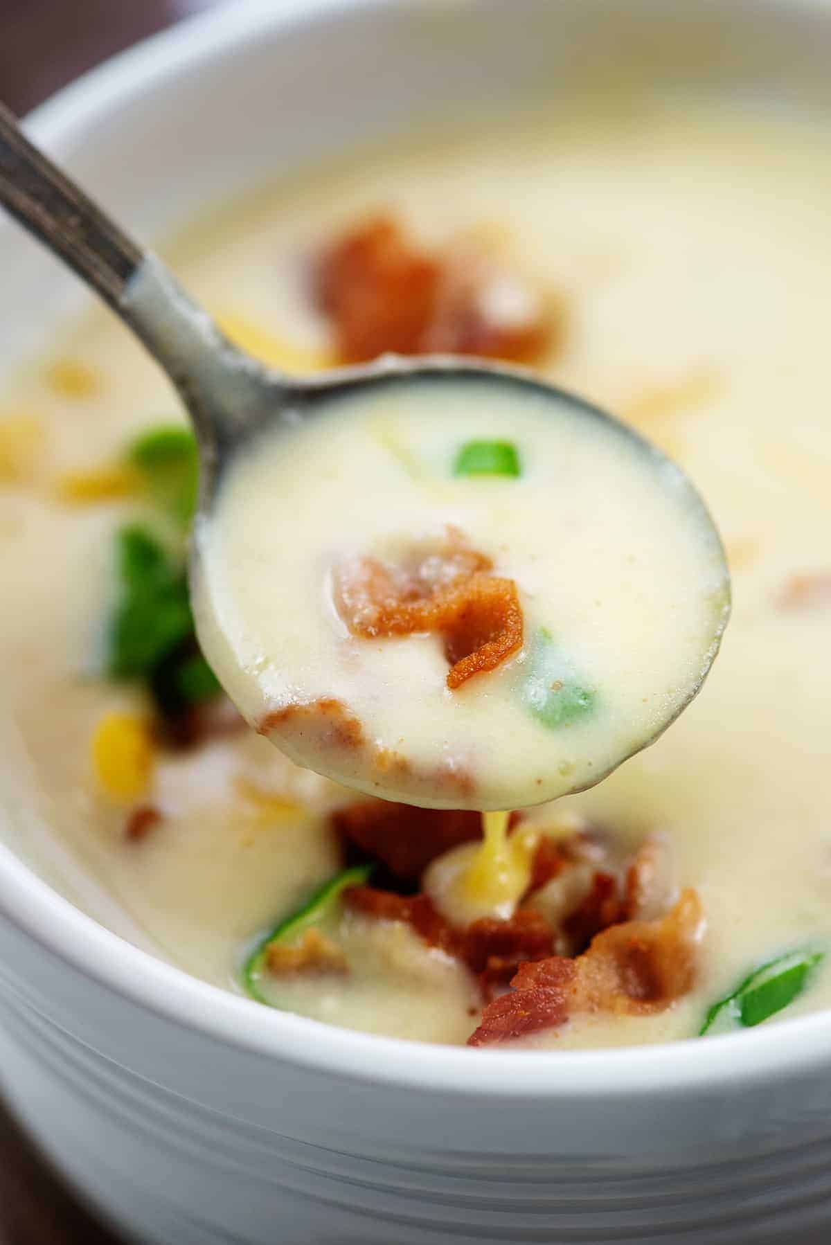 cheesy cauliflower soup on vintage spoon.