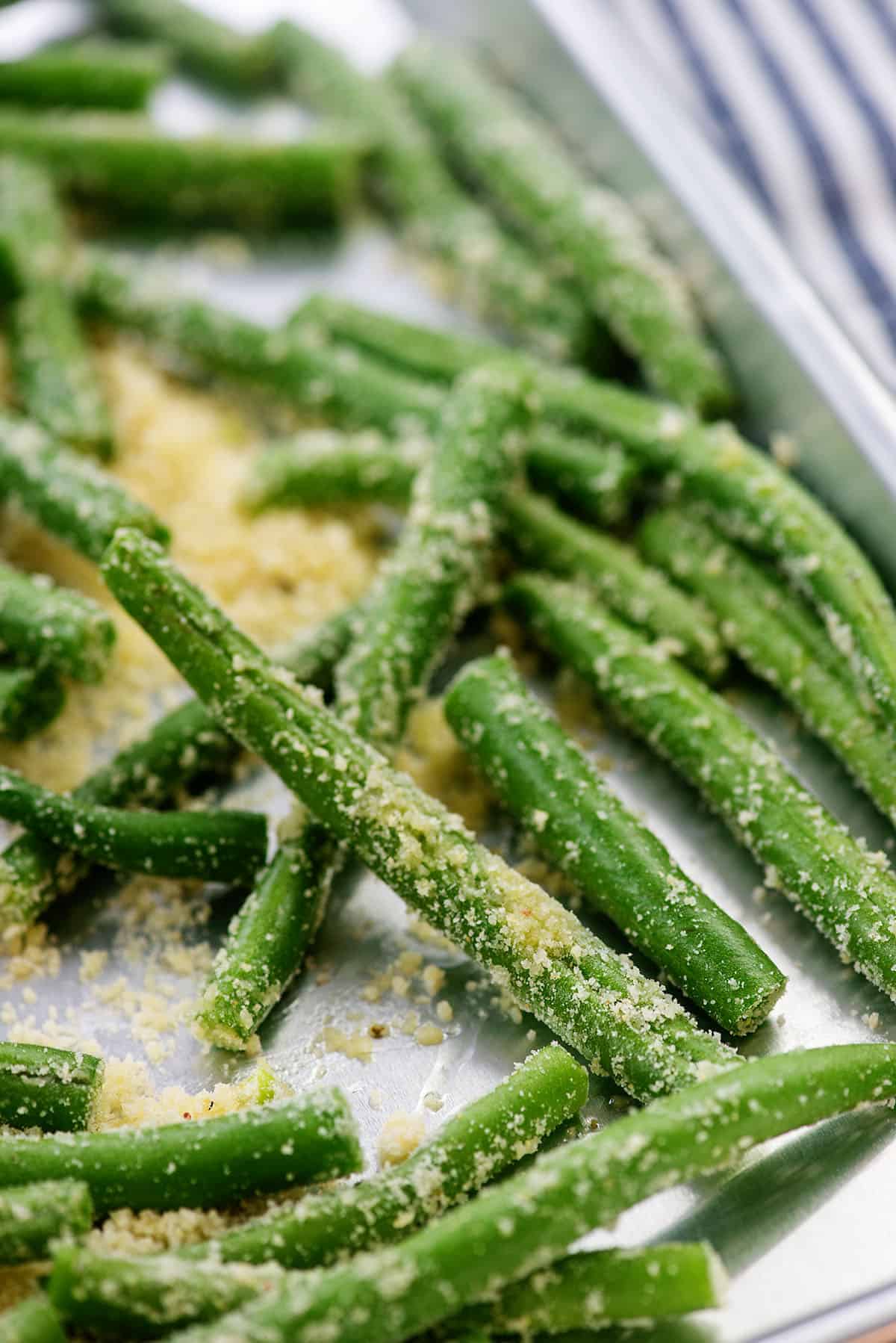 coated green beans on baking sheet.