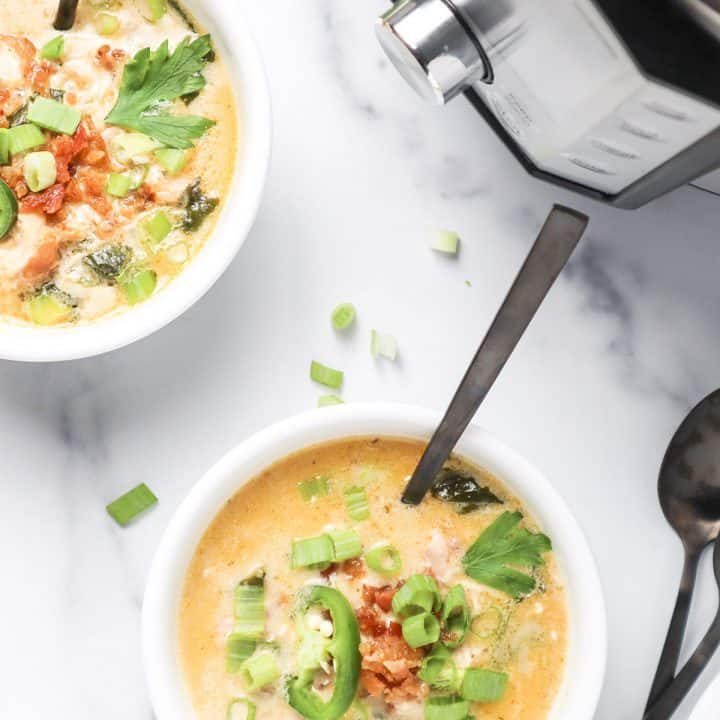 overhead view of cajun ranch soup in white bowls.