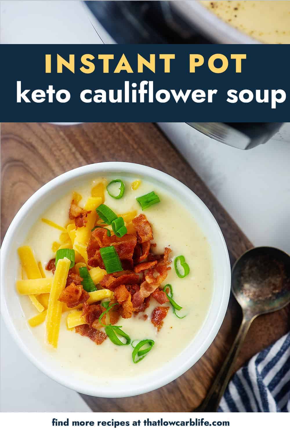 white bowl full of keto cauliflower soup topped with bacon and cheese.