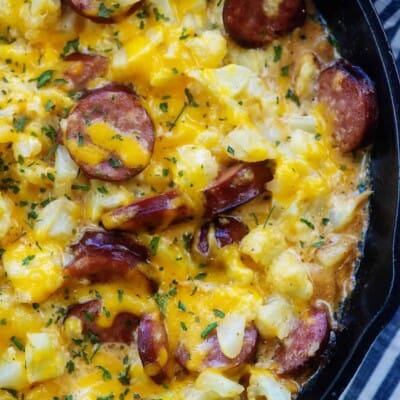 cast iron skillet full of baked cauliflower mac and cheese.