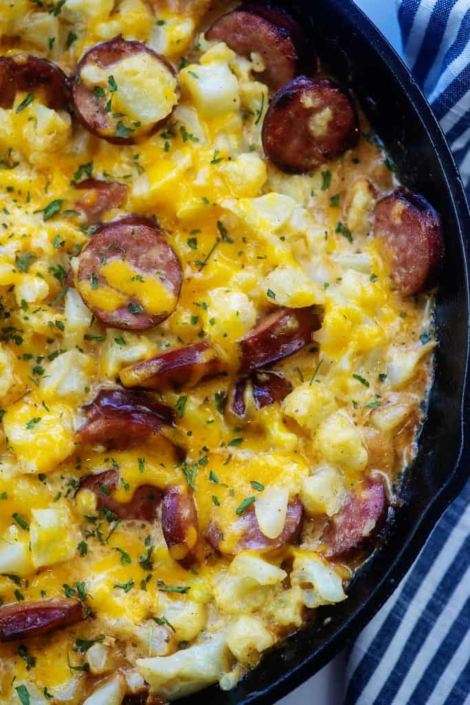 cast iron skillet full of baked cauliflower mac and cheese.