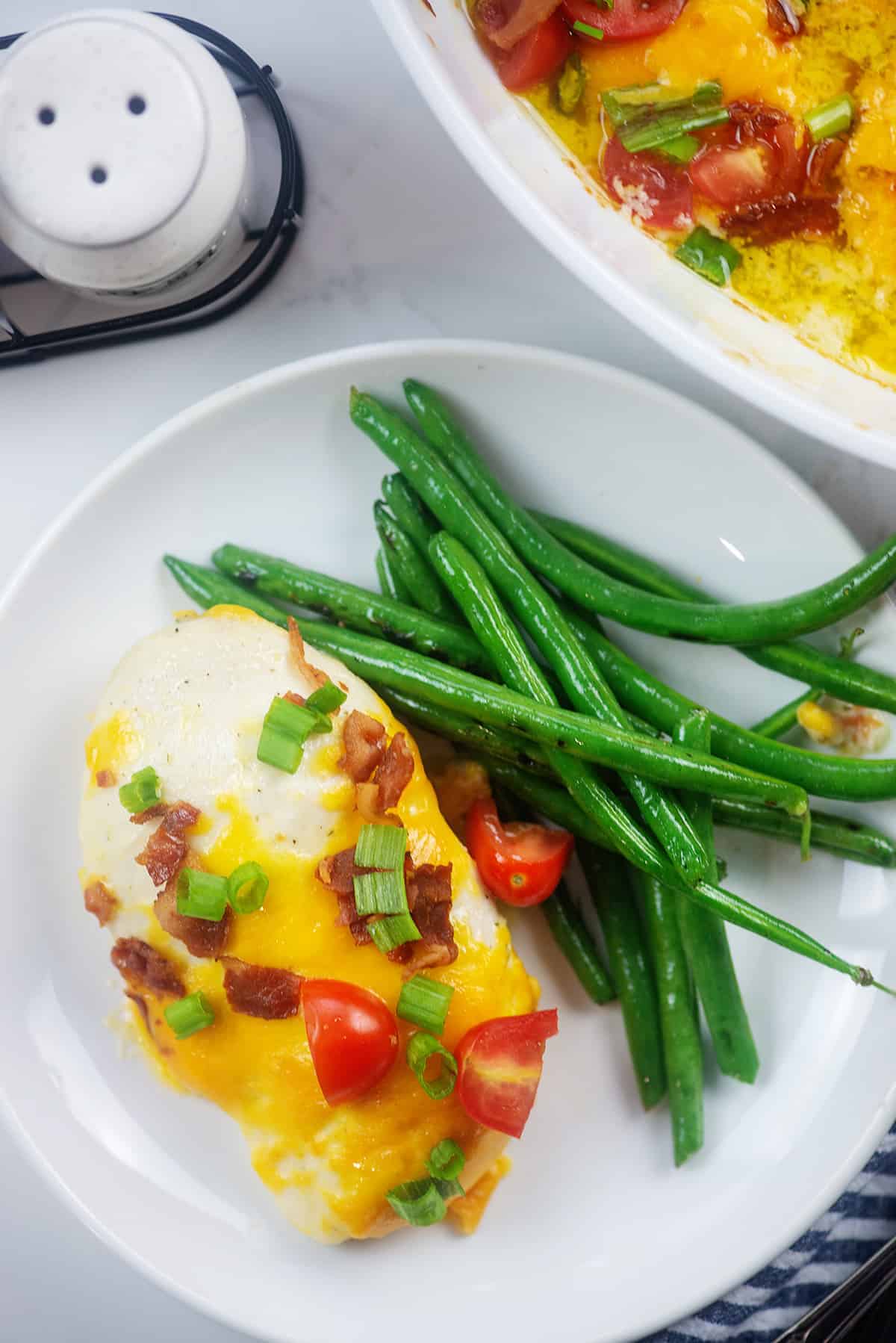 easy baked chicken topped with cheese and bacon.