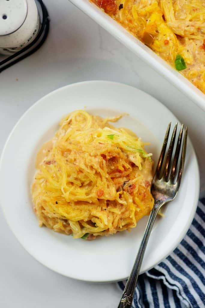 cheesy keto spaghetti squash recipe on white plate.