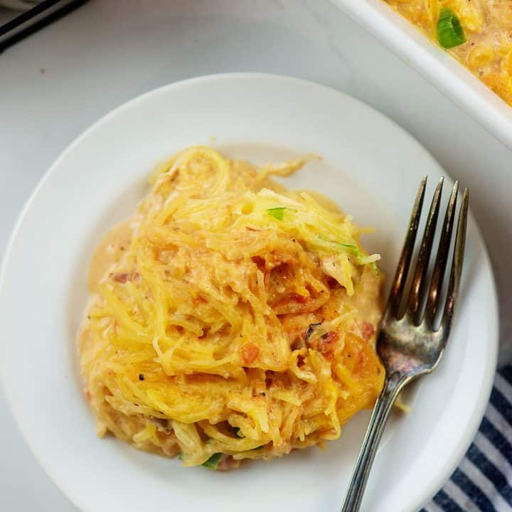 cheesy keto spaghetti squash recipe on white plate.