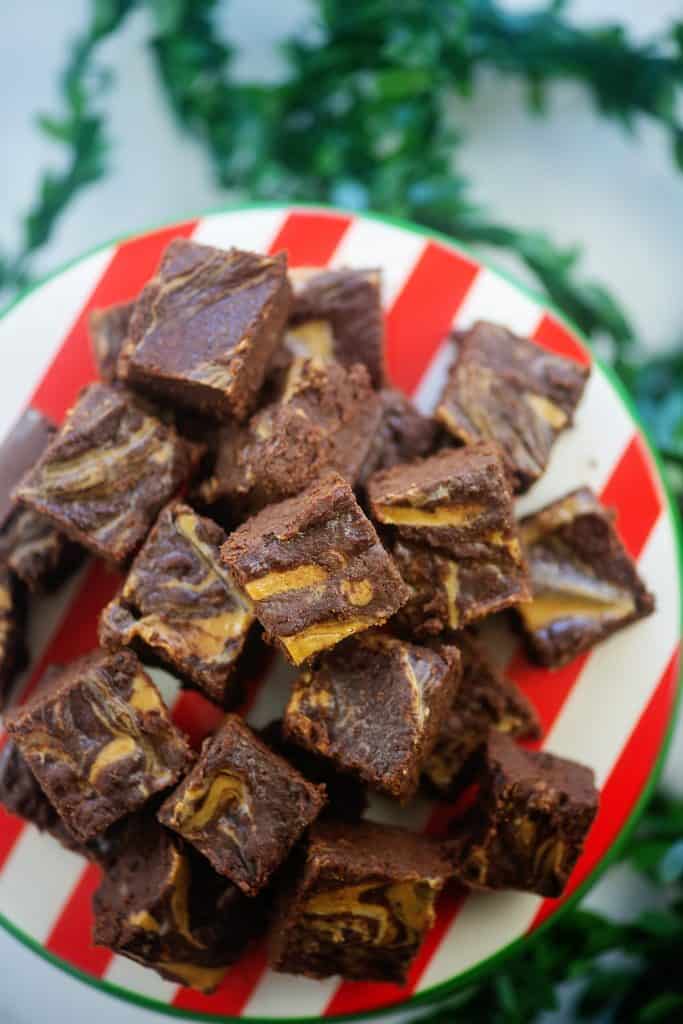 pile of chocolate peanut butter fudge on cake stand.