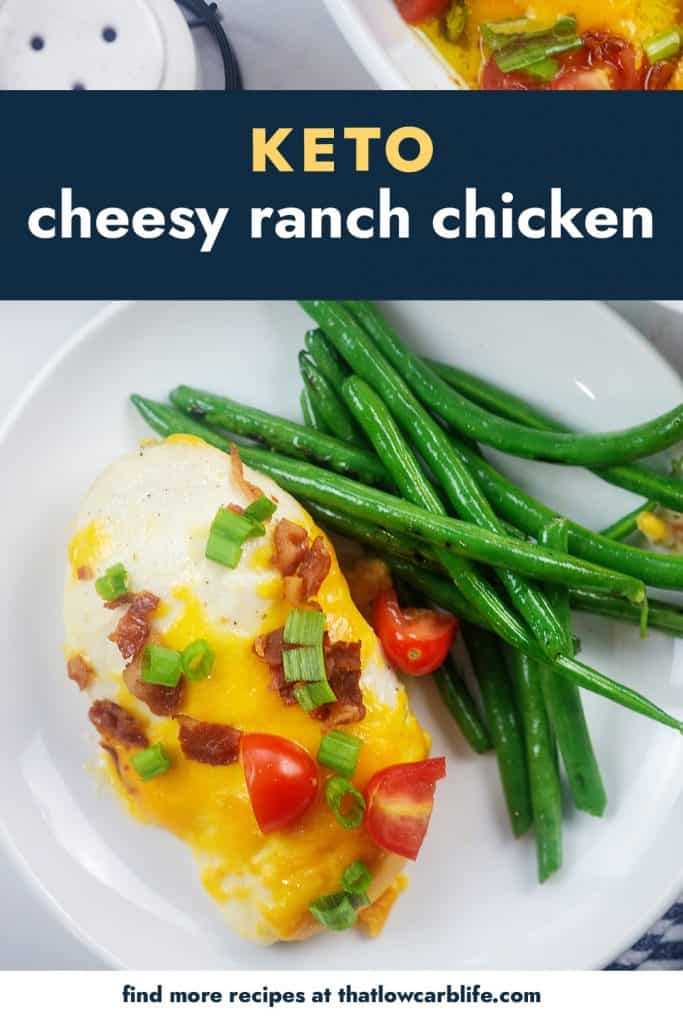 overhead view of cheesy baked chicken recipe on plate with green beans.