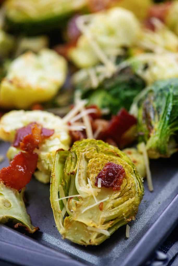 low carb roasted Brussels sprouts with bacon and Parmesan on baking sheet.