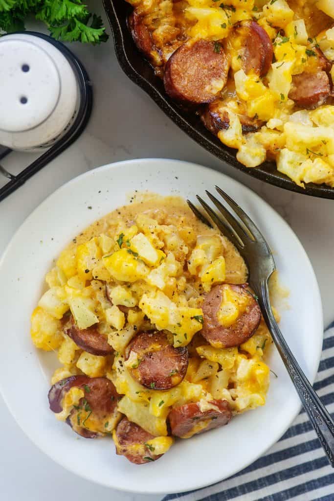 plateful of baked cauliflower macaroni and cheese with sausage.