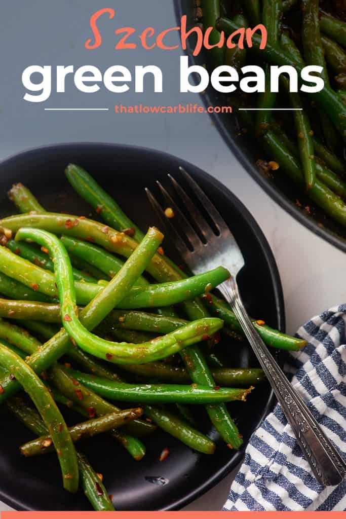 overhead view of Asian green beans on black plate.