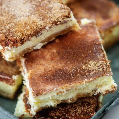 keto snickerdoodle cheesecake bars piled in metal dish.