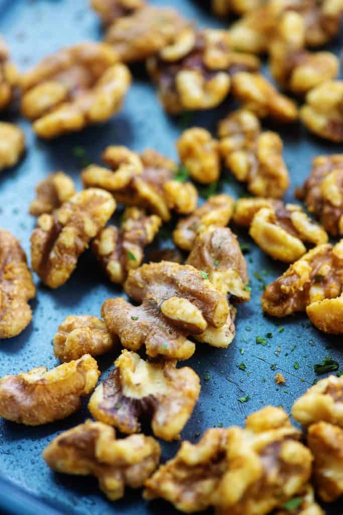 seasoned walnuts spread on baking sheet.