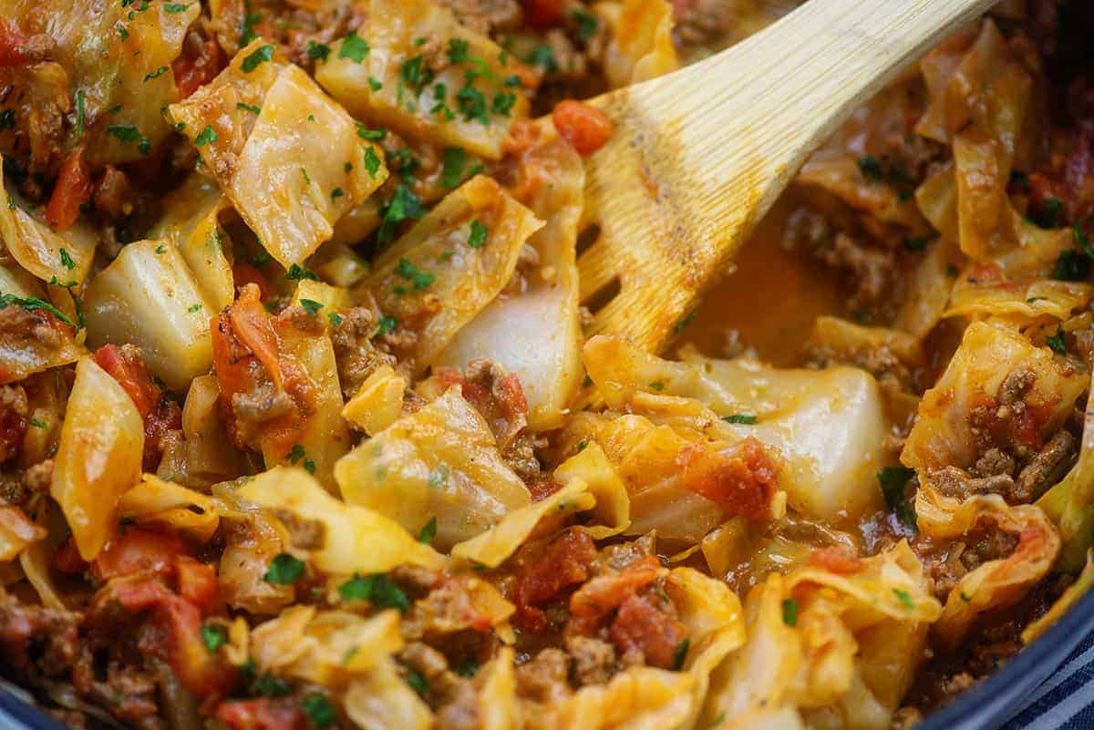 pot full of keto cabbage casserole with wooden spoon.