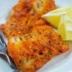 Parmesan crusted cod on white plate.