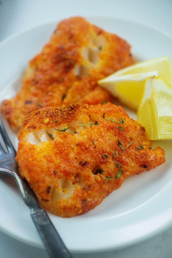 Parmesan crusted cod on white plate.