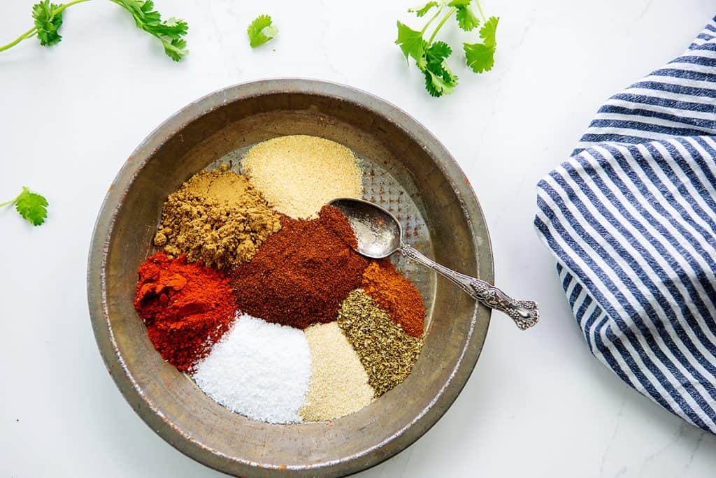 overhead view of spices in bowl for taco seasoning recipe.