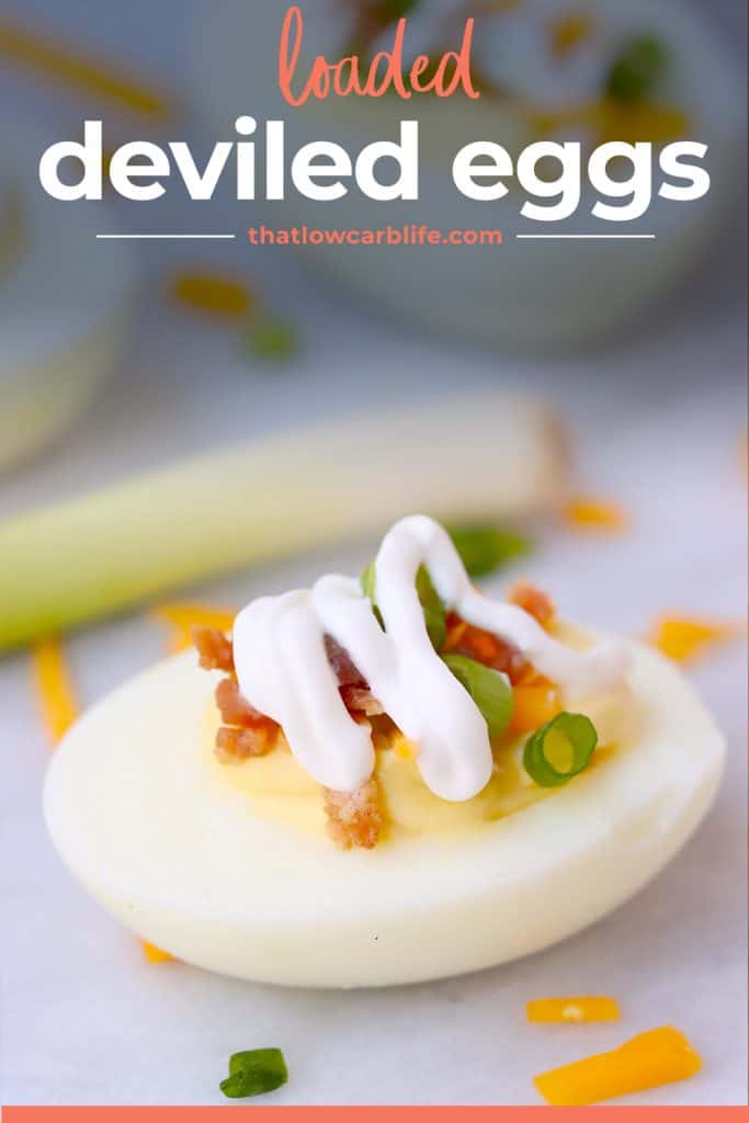 deviled egg topped with a drizzle of sour cream.